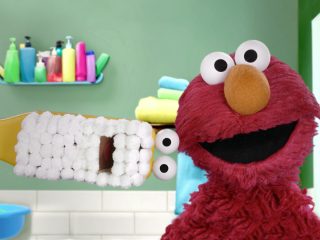 Elmo and a toothbrush dancing.