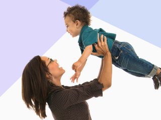 A women lifting her child in the air.