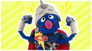 Grover, dressed as a super hero, flexes his biceps.