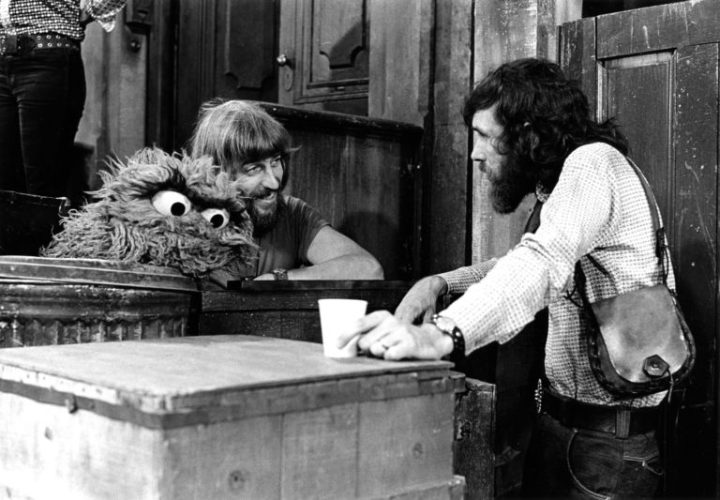 Carroll Spinney, operating Oscar the Grouch, chats with Jim Henson on the Sesame Street set.