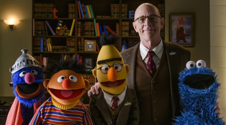 Spokesperson J.K. Simmons poses with Super Groer, Ernie, Bert, and Cookie Monster.