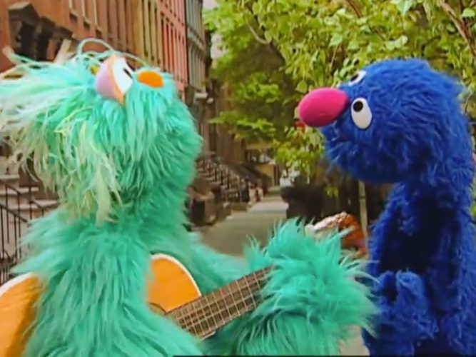 Grover listens to Rosita play the guitar