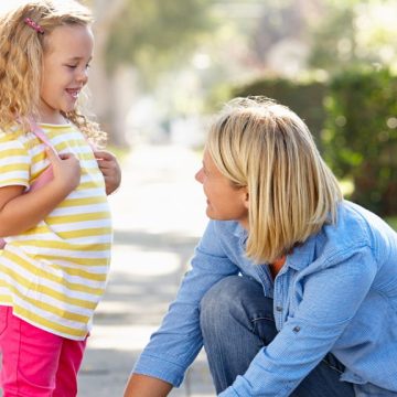 A parent tying their child