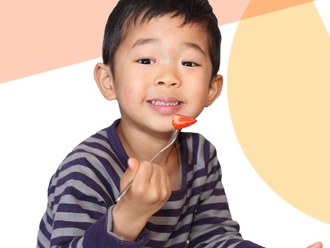 Child eating a strawberry.