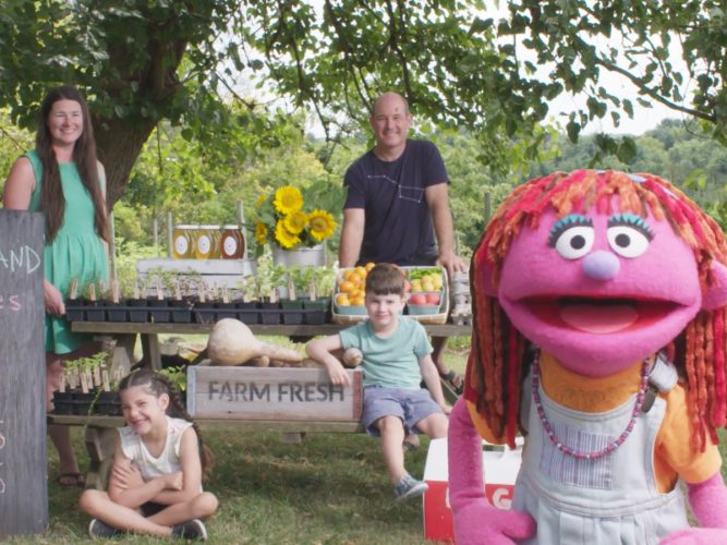 Lily with a family at a farm stand.