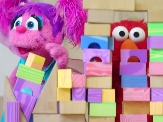 Elmo and Abby play with a block tower