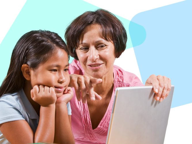 A caregiver and a child look at a laptop