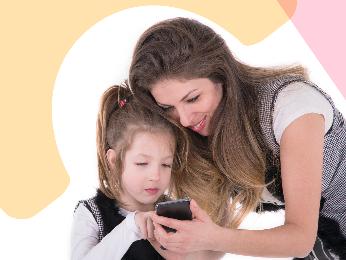 A parent showing her child something on a a phone.