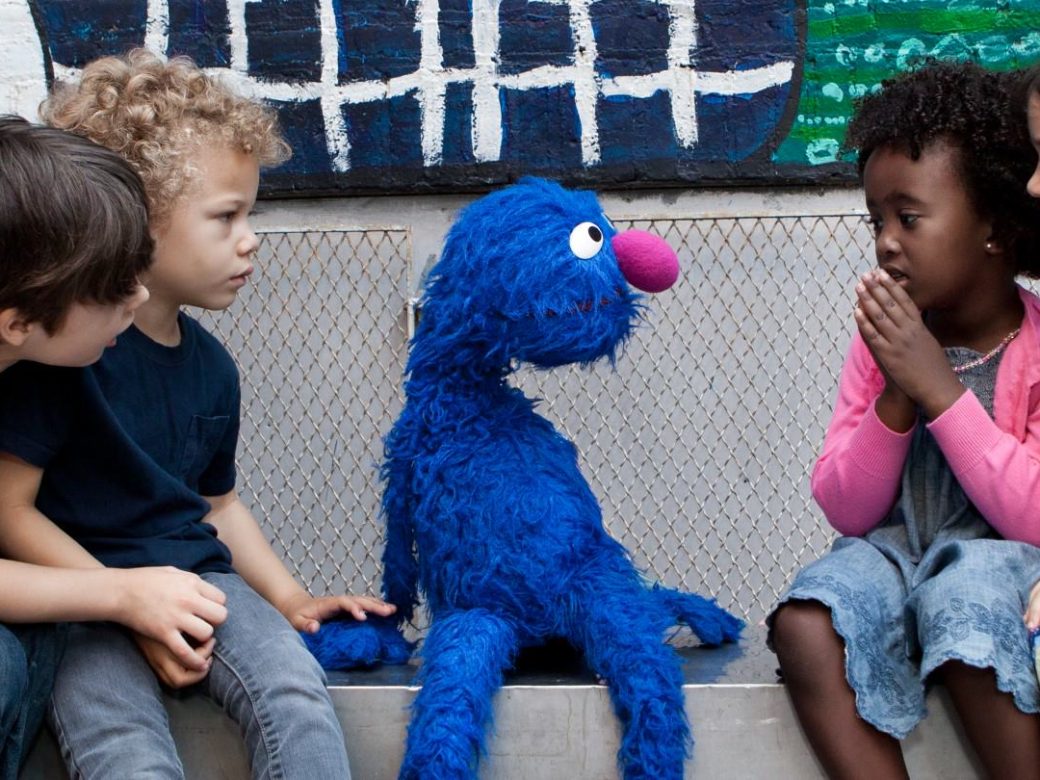 Grover sitting with a group of children.