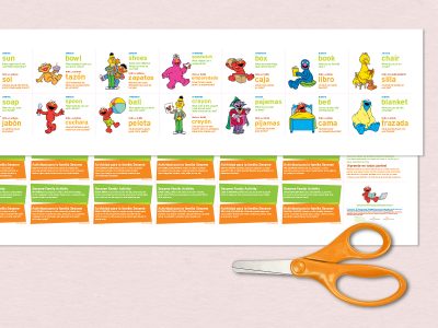 Scissors lay next a printable paper card game.