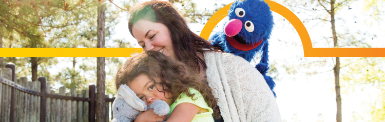 Grover hugging a family.