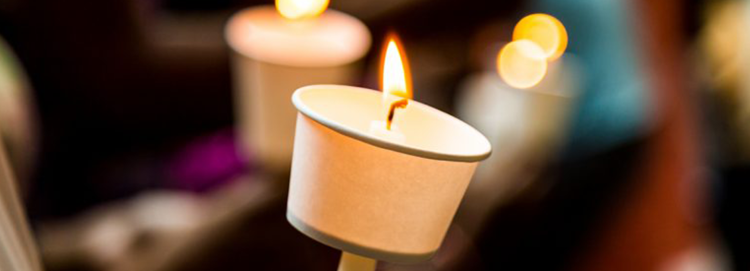Multiple candles lit depicting a vigil.