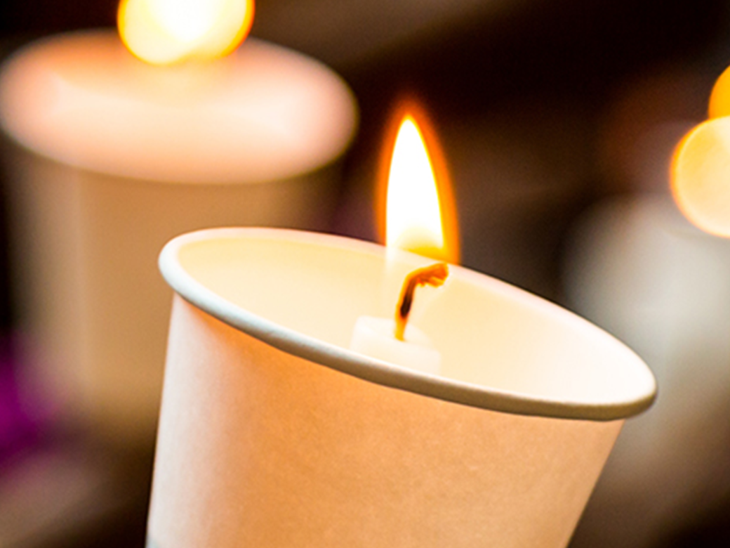 Multiple candles lit depicting a vigil.