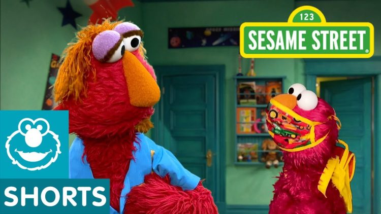 Elmo wears a mask while talking to his dad