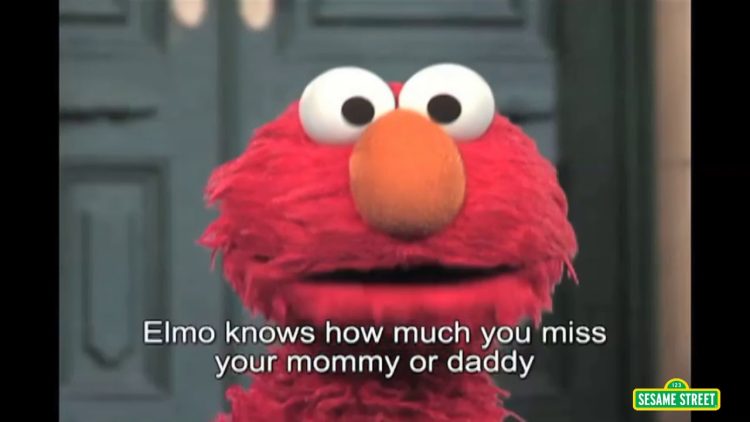 Elmo looks at us. A caption reads: Elmo knows how much you miss your mommy or daddy.