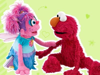 Abby comforts Elmo by touching his arm.