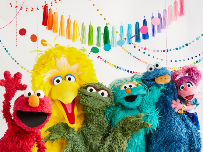 Elmo, Ernie, Bert, Big Bird, Oscar the Grouch, Rosita, Cookie Monster, Grover, and Rosita all pose together