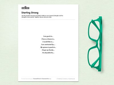 A print out of the activity lays on a green background next to a pair of green classes