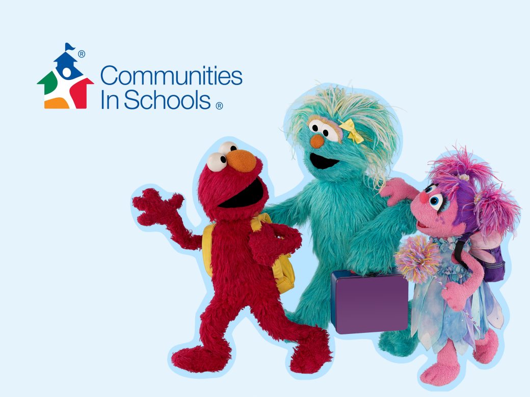 Elmo, Rosita, and Abby wear backpacks and walk together.