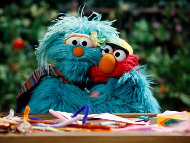 Rosita and Elmo hug each other tightly.