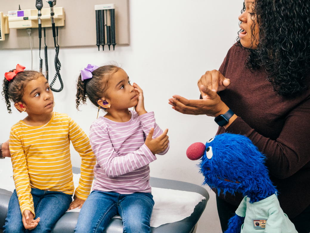 Grover with a provider and a group of children.