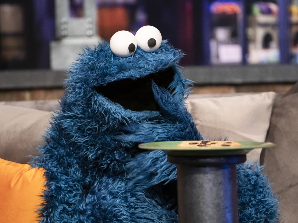 Cookie Monster staring in awe at a Cookie
