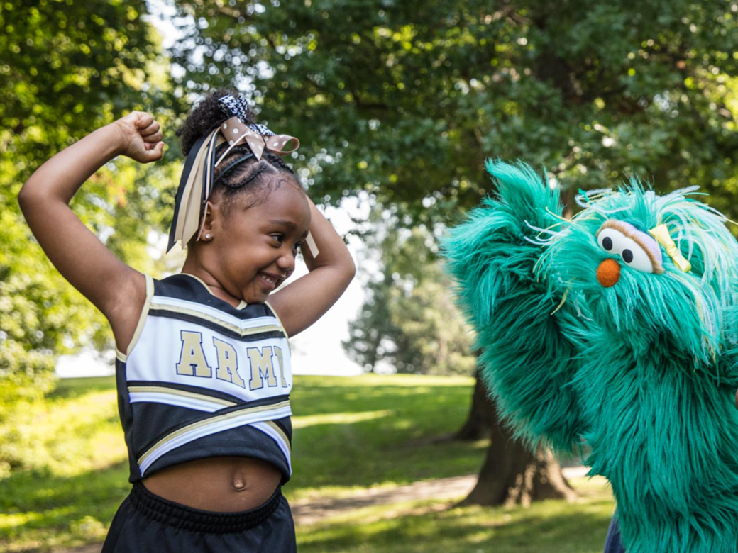 Rosita flexes her muscles with a young cheerleader and a military father.