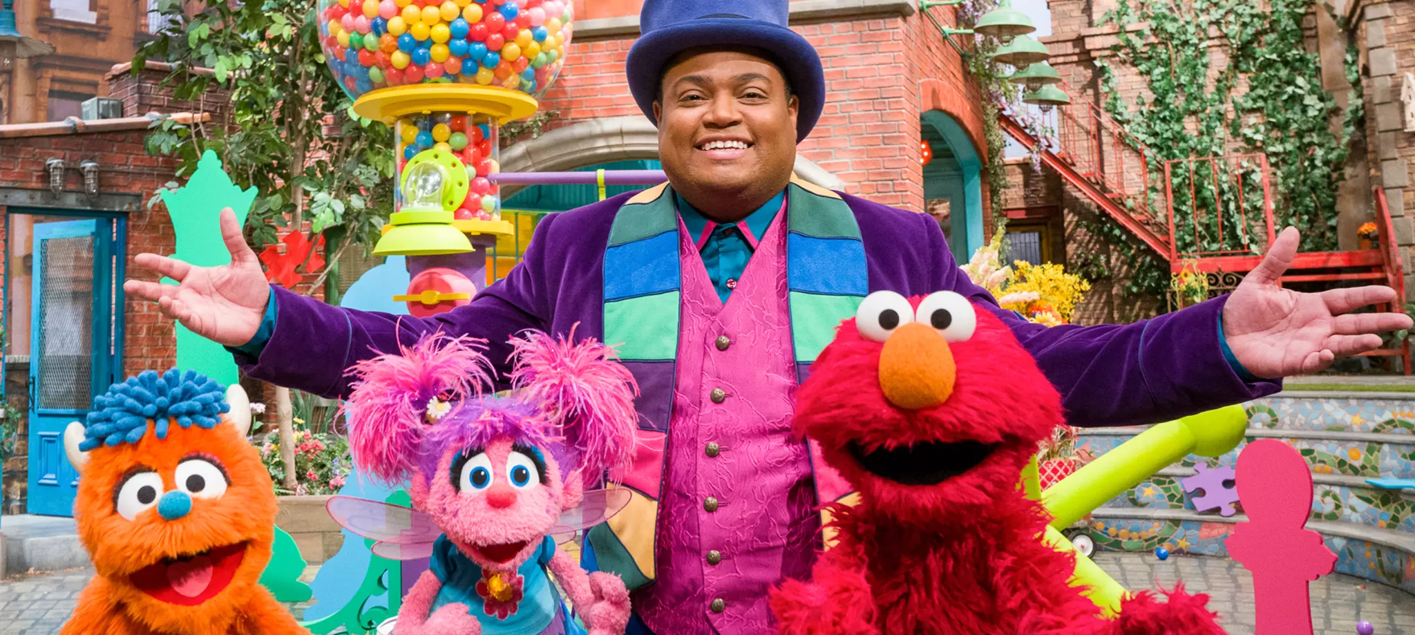 Chris, dressed as a ringleader, poses with Rudy, Abby, and Elmo