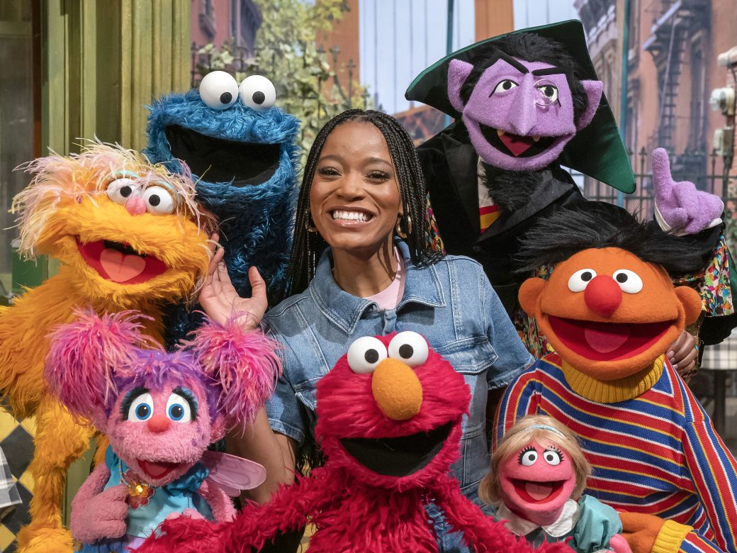 Keke Palmer poses with the Muppets of Sesame Street