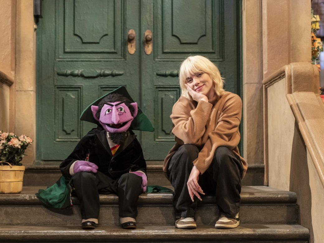 Billie Eilish sits with The Count on the stoop of 123 Sesame