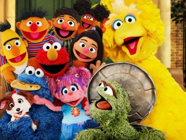 A big group of the Muppets have a group hug.