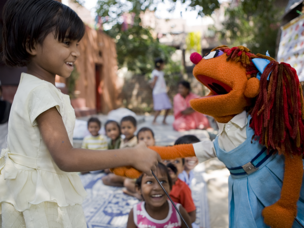 Chamki shakes a young girl's hand