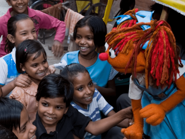 Chamki smiling with group of young girls.