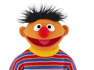Ernie smiles at us. He's wearing a horizontally striped shirt.