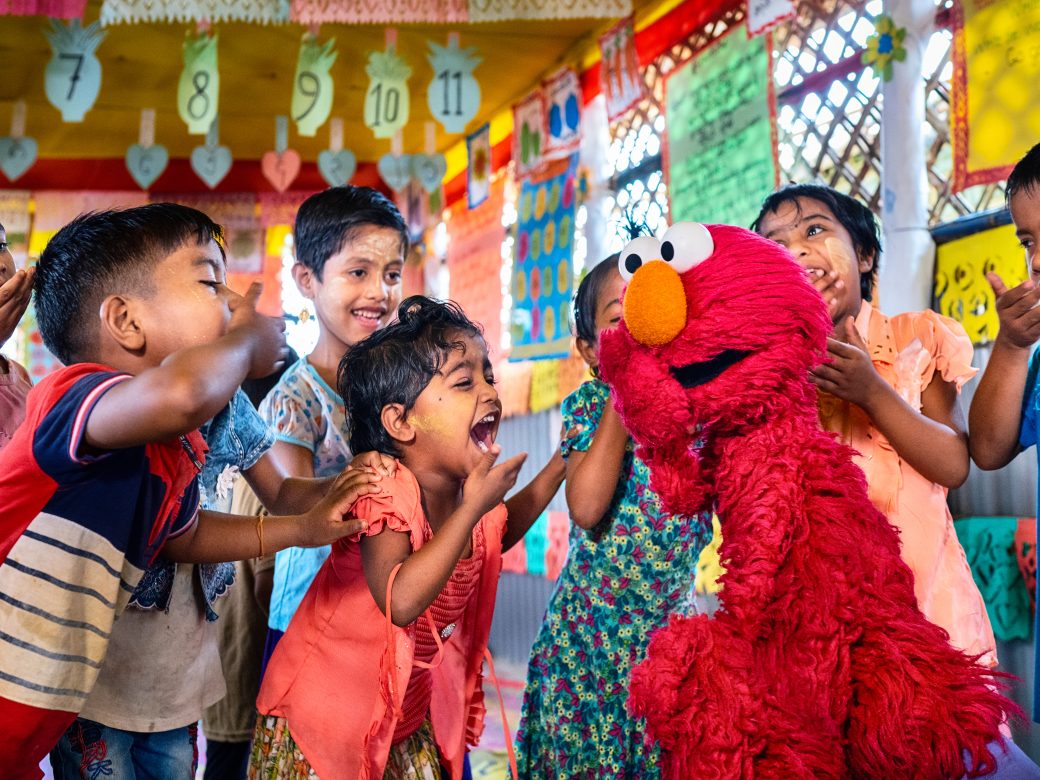 Elmo laughing and playing with children
