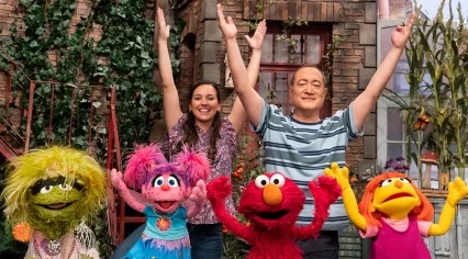 Nina and Alan join some Sesame Street muppets in stretching