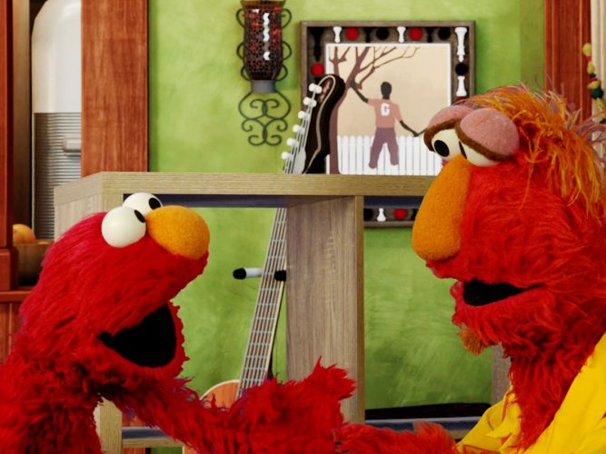 Elmo excitedly talking to his dad