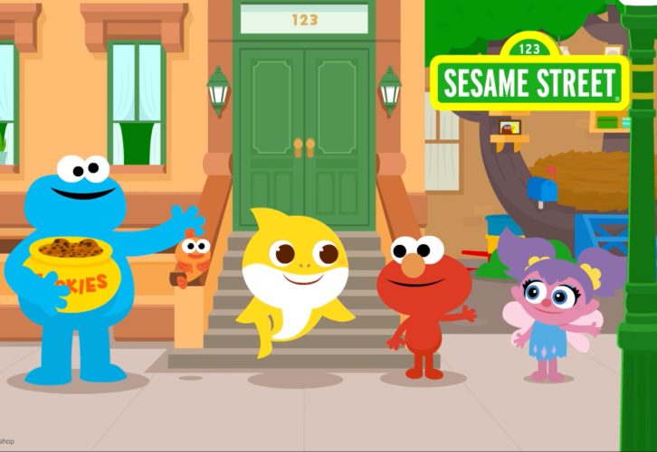 Cookie Monster, Elmo, and Abby pose with Baby Shark on Sesame Street.