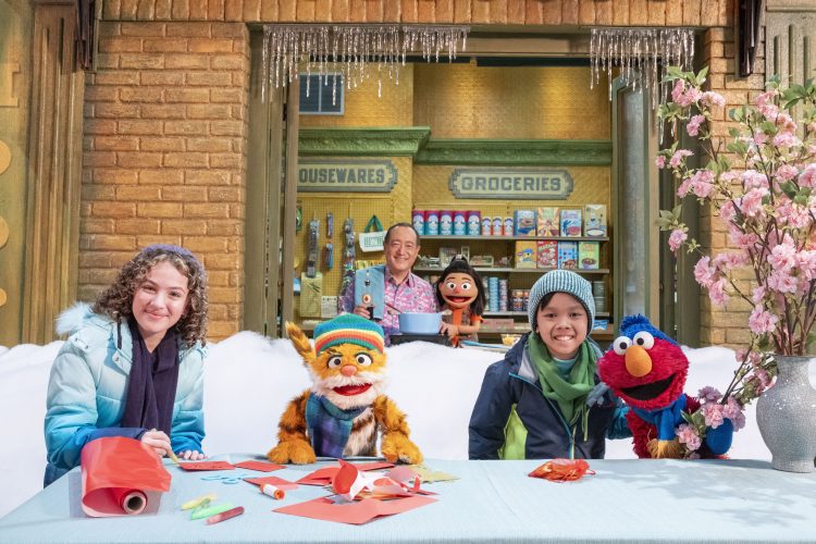 Charlie and friends sitting outside in winter coats.