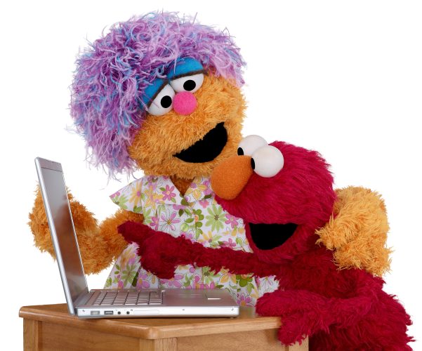 Elmo and mae with a laptop.