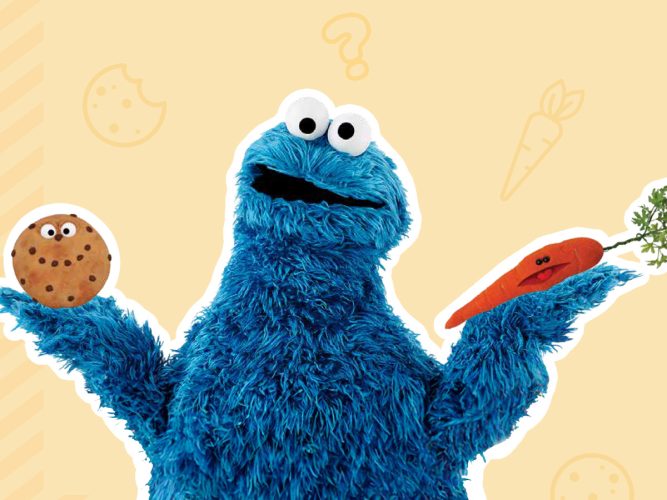 Cookie Monster holding a cookie and a carrot.