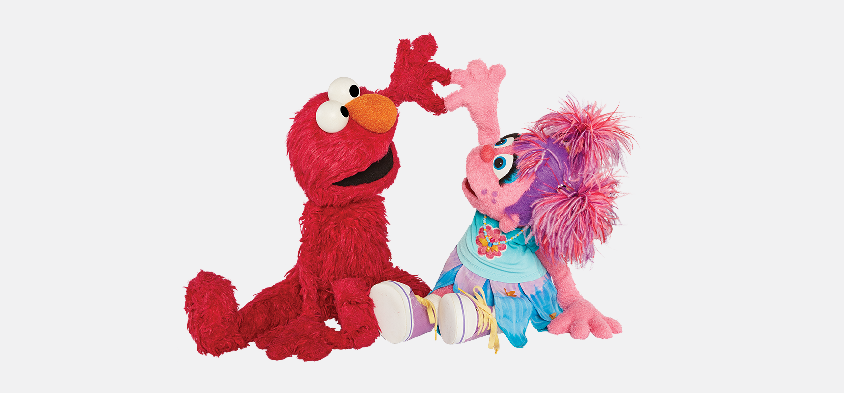 Elmo and Abby making a heart with their hands.