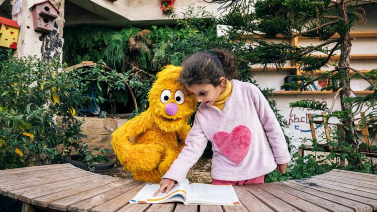 Jad reading with a child.