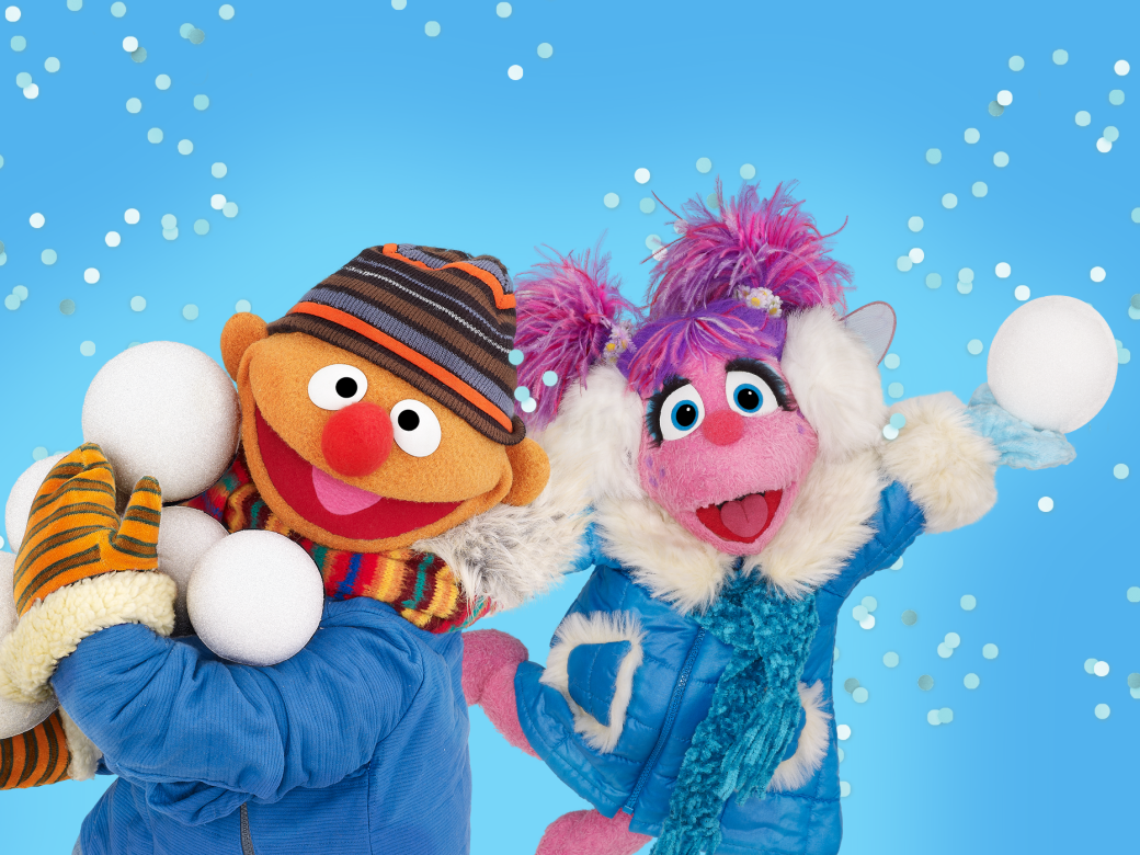 Ernie and Abby pose in a winter wonderland with snowballs