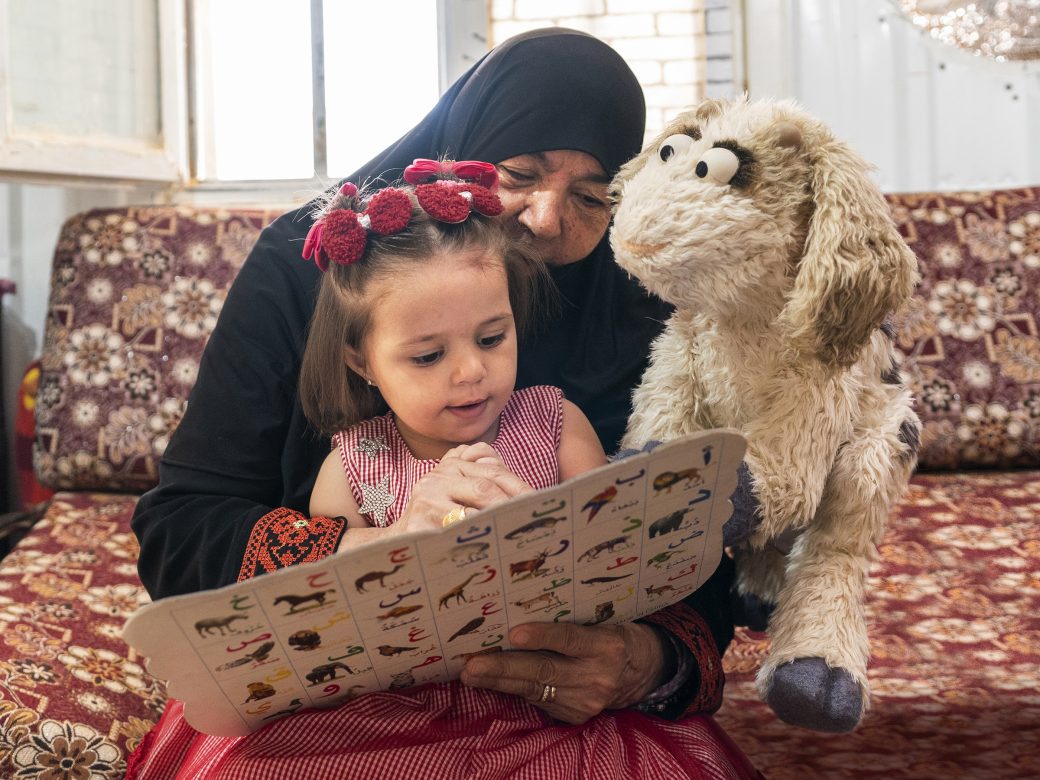 A parent reading to a child.