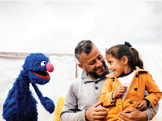 A parent and child with Grover