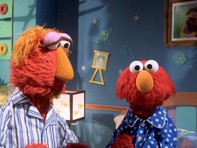 Elmo and Louie in bed.