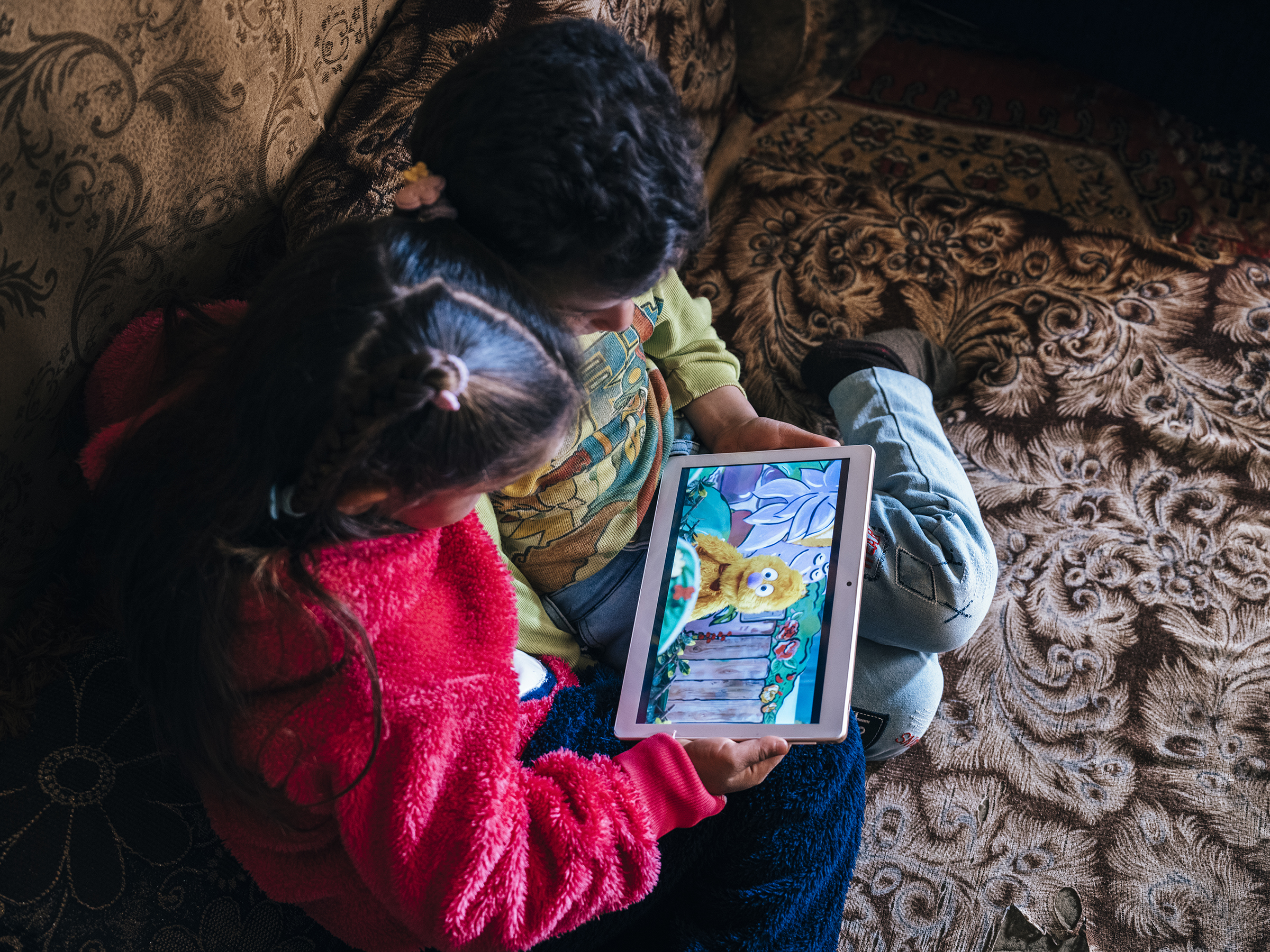 Children looking at a tablet device.