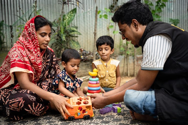 IRC project staff playing with children during home visit monitoring