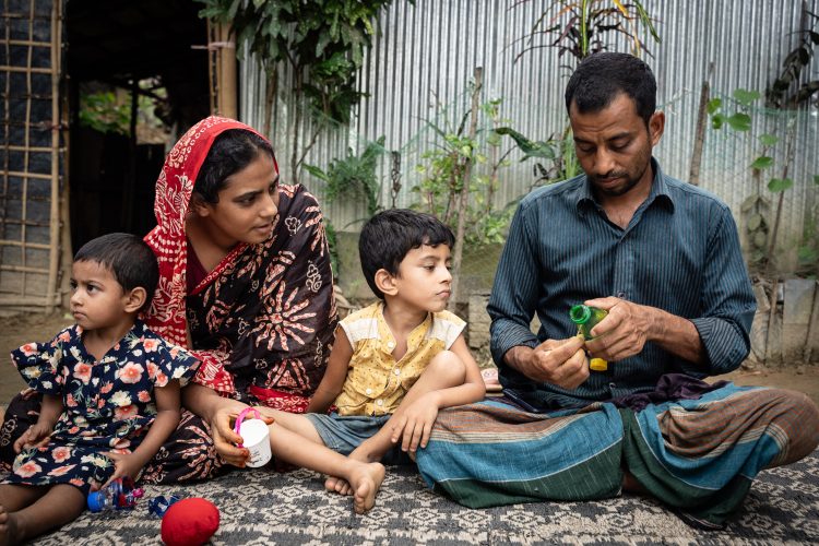 Father is making toy car for the child using bottle